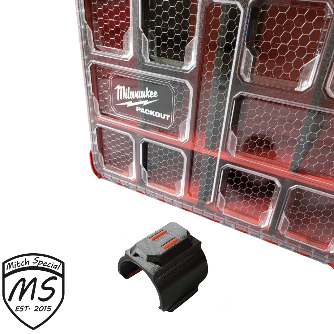 Sturdy black holder securely clipped to a Milwaukee Packout case, emphasizing its perfect fit and robust design for organizing tools.