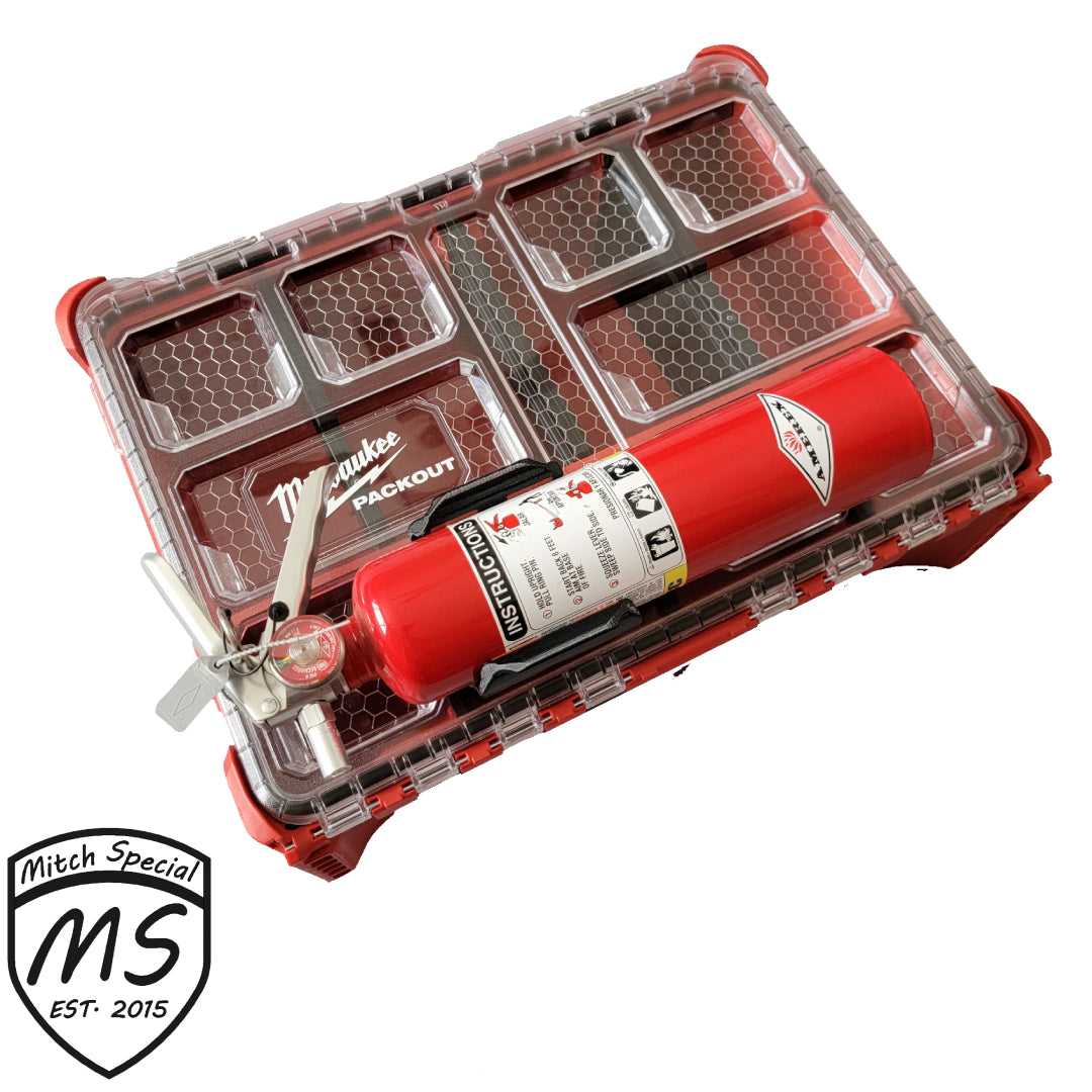 A red fire extinguisher securely mounted on a Milwaukee Packout storage case with a transparent lid and multiple compartments.