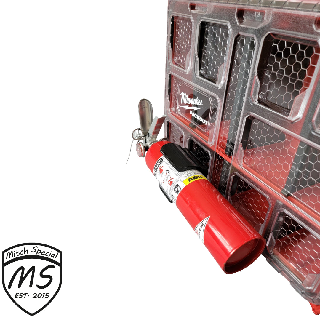 A red fire extinguisher mounted on a Milwaukee Packout case using a specialized black holder, designed for secure attachment.