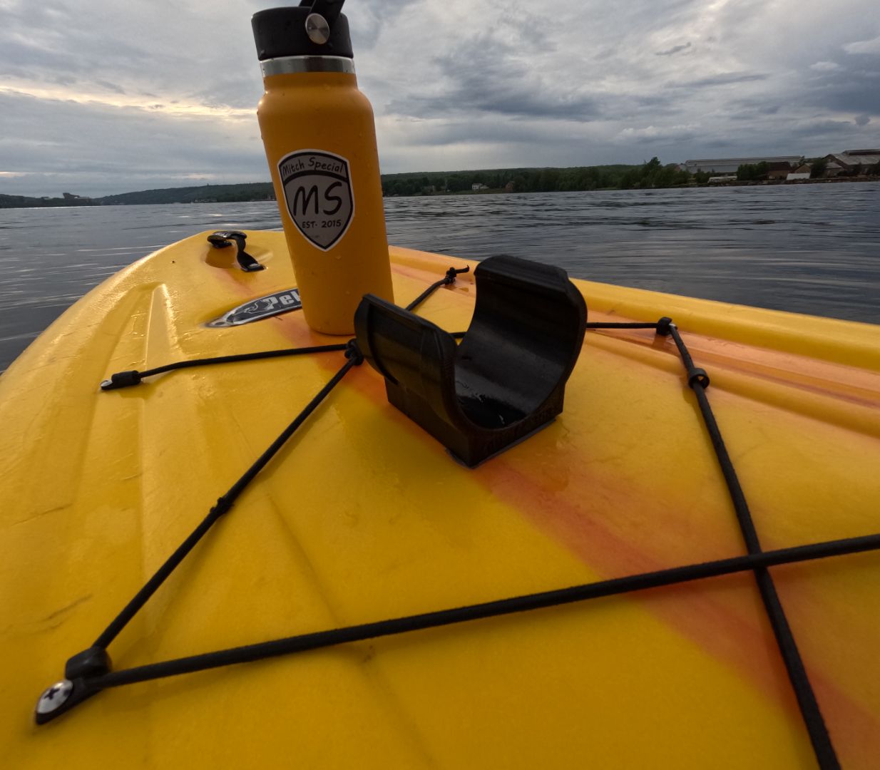 Yellow paddle board with a water bottle holder secured by high-strength 3M VHB tape. Holder contains a bottle labeled 'MS Est. 2015'