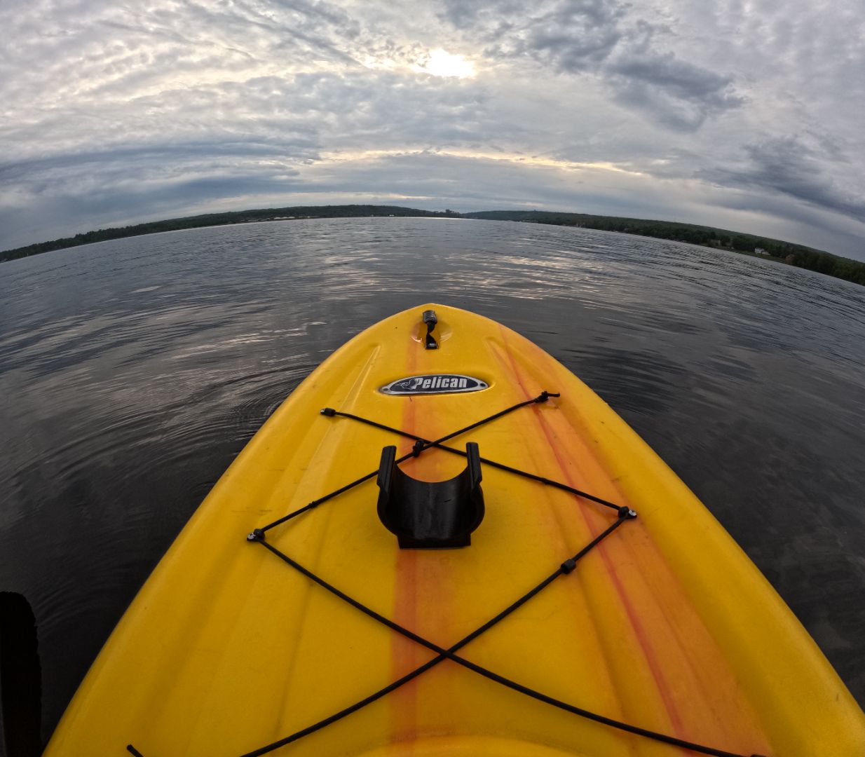 Yellow Pelican paddle board with a water bottle holder secured by high-strength 3M VHB tape, floating on a calm lake.