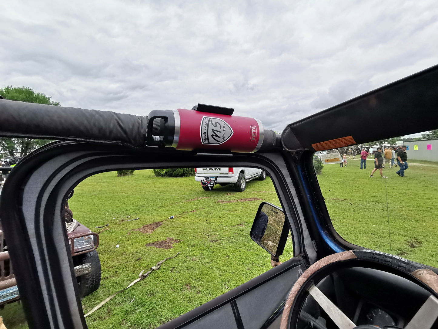Jeep YJ water bottle holder mounted to roll bar, designed for secure attachment and easy access during off-road adventures.