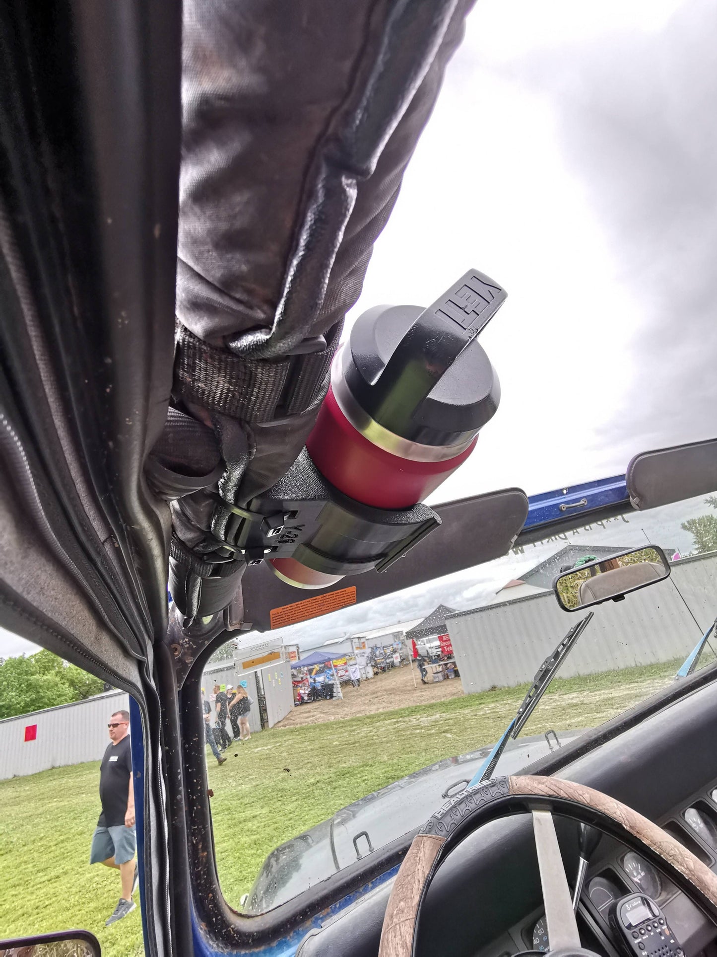 Jeep YJ water bottle holder mounted to roll bar, providing a secure and accessible solution for off-road hydration.