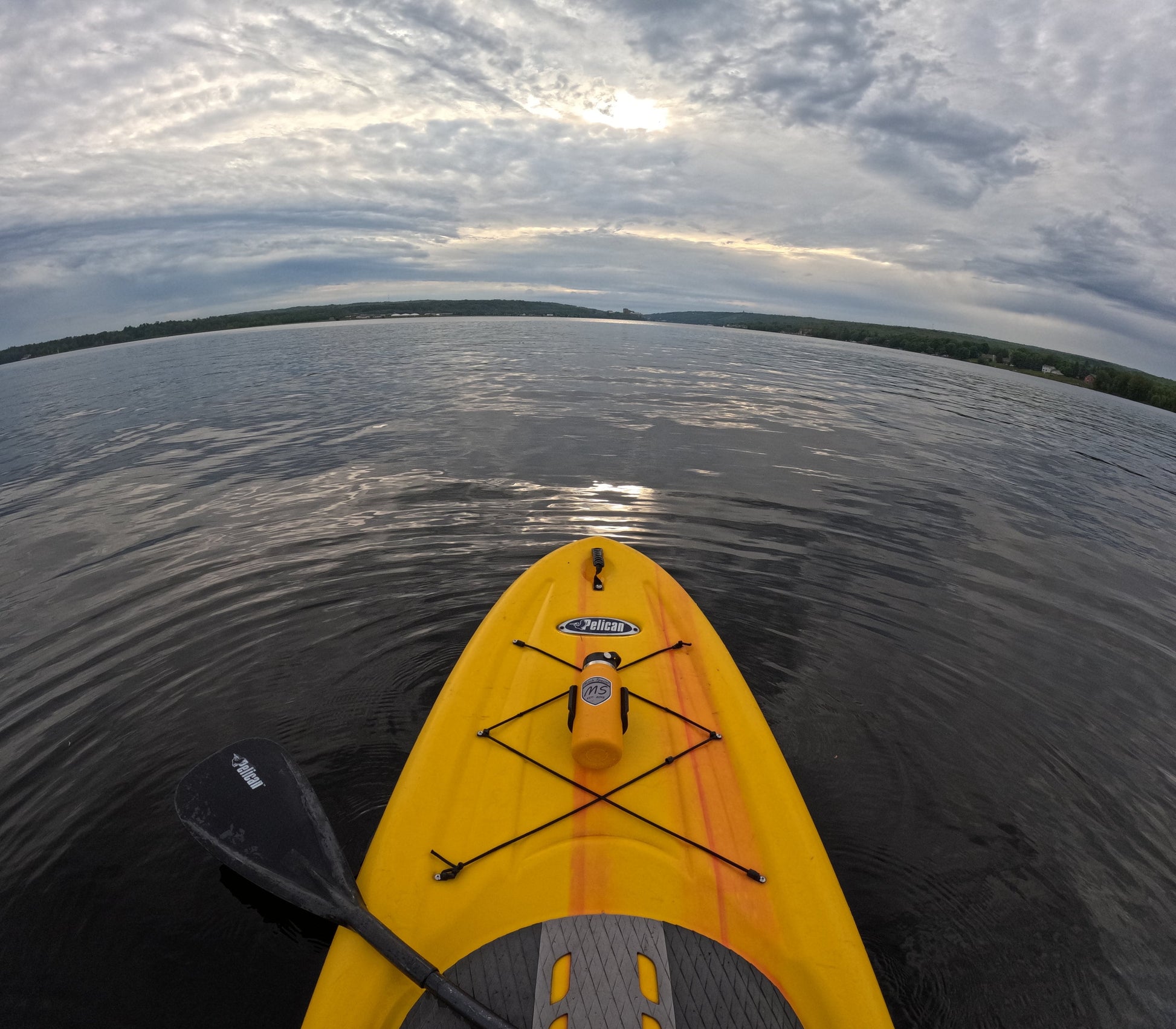 "Black holder securely mounted on a yellow kayak using 3M VHB tape, designed for universal attachment and holding a blue water bottle.