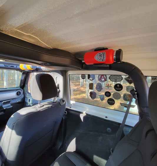 Jeep JL with water bottle holder mounted on the roll bar near the roof, securing a red water bottle with ample headroom.