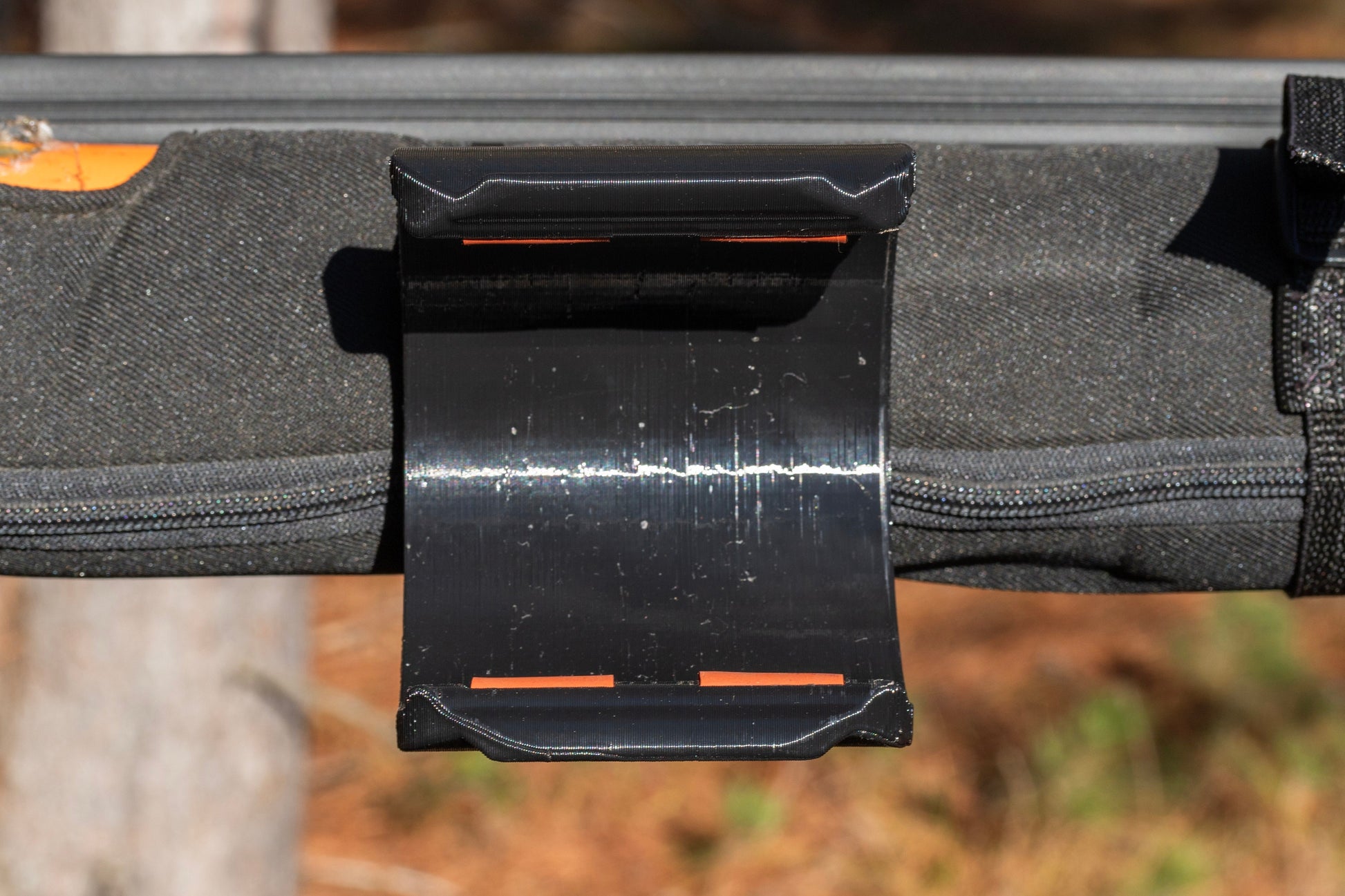 Close-up of Jeep JK roll bar water bottle holder, roofless view, demonstrating robust design and secure fit for off-road adventures.