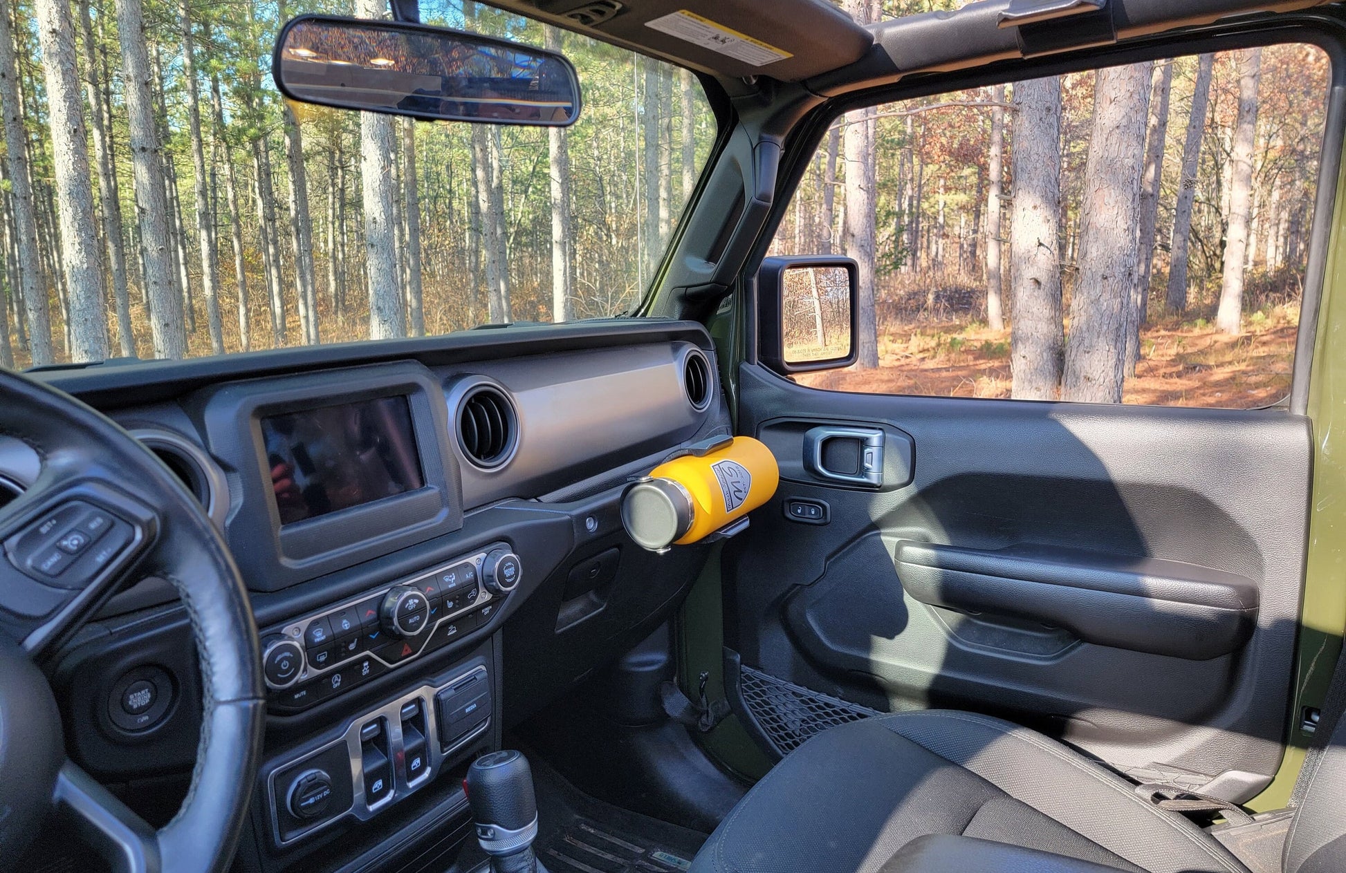 Angled view of Water Bottle Holder for Jeep JL mounted to grab handle, highlighting its sleek design and sturdy construction